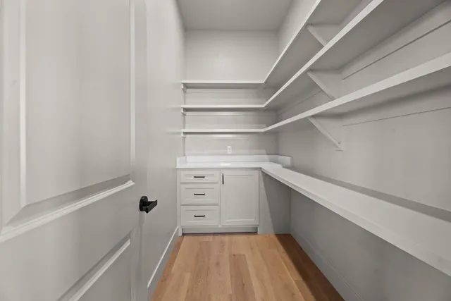 a view of walk in closet with empty racks
