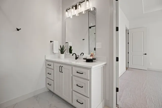 a bathroom with a double vanity sink mirror and
