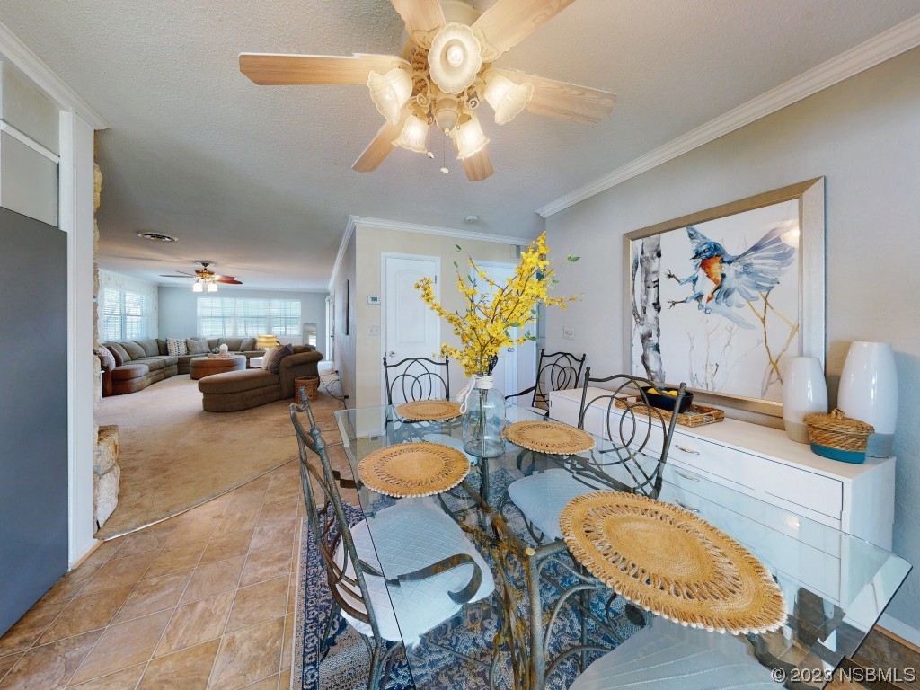 18 Silk Oaks Drive Ormond Beach, FL 32176 - Photo 11 of 46 a living room with furniture and a chandelier