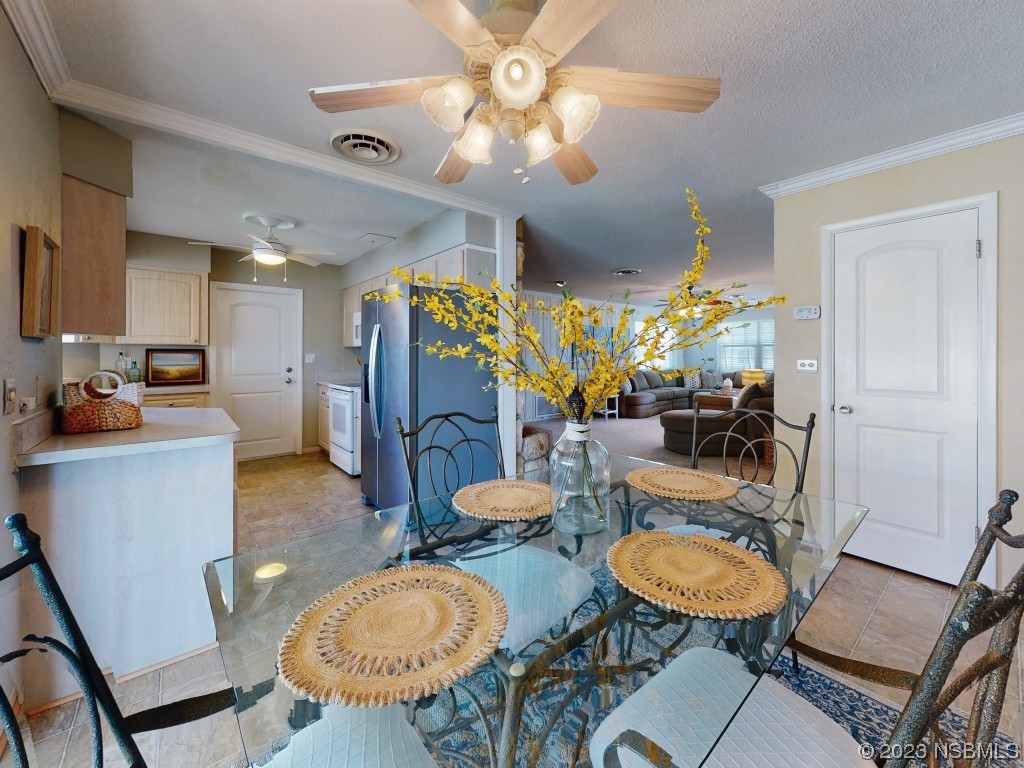 18 Silk Oaks Drive Ormond Beach, FL 32176 - Photo 12 of 46 a dining room with furniture a chandelier and wooden floor