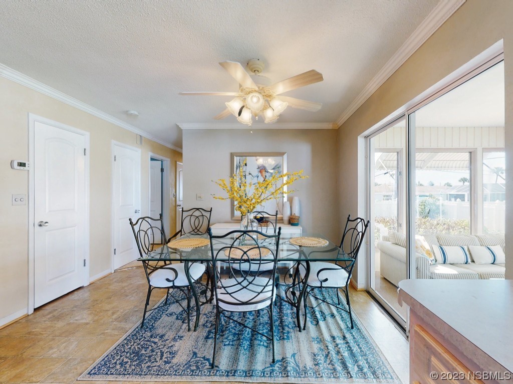 18 Silk Oaks Drive Ormond Beach, FL 32176 - Photo 14 of 46 a view of a dining room with furniture a chandelier and large windows