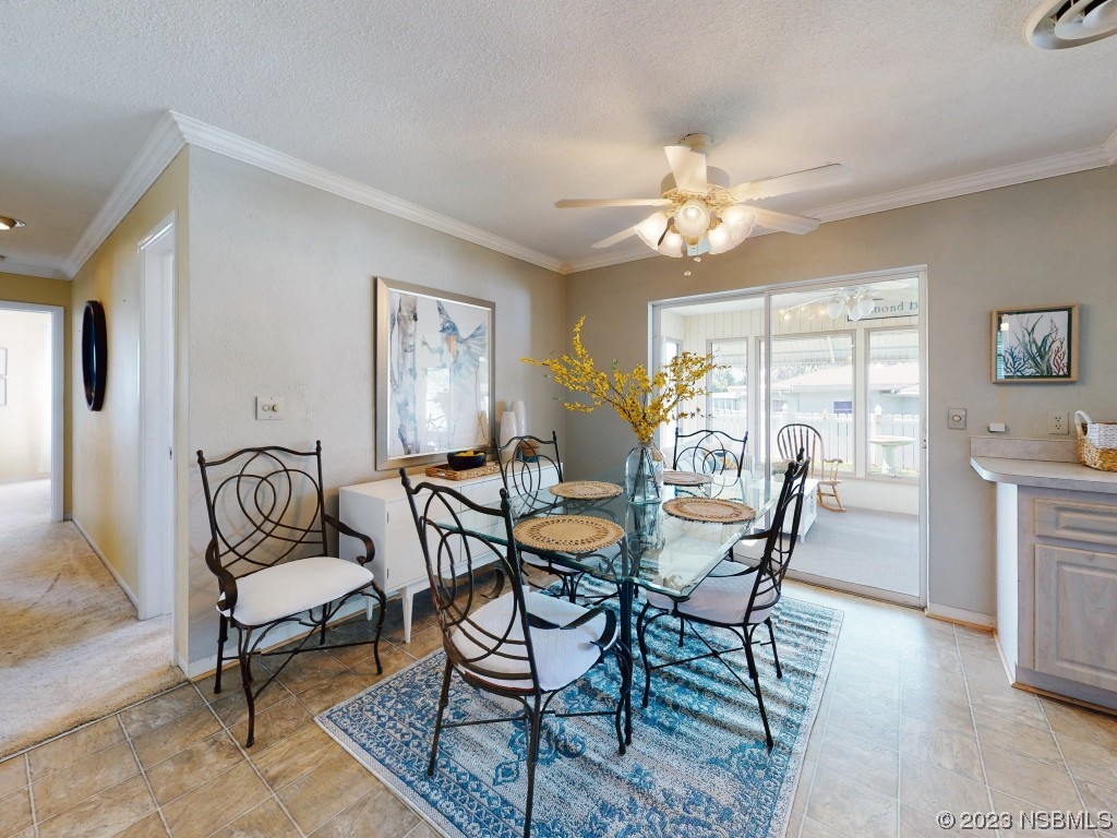 18 Silk Oaks Drive Ormond Beach, FL 32176 - Photo 15 of 46 a view of a dining room with furniture and a chandelier