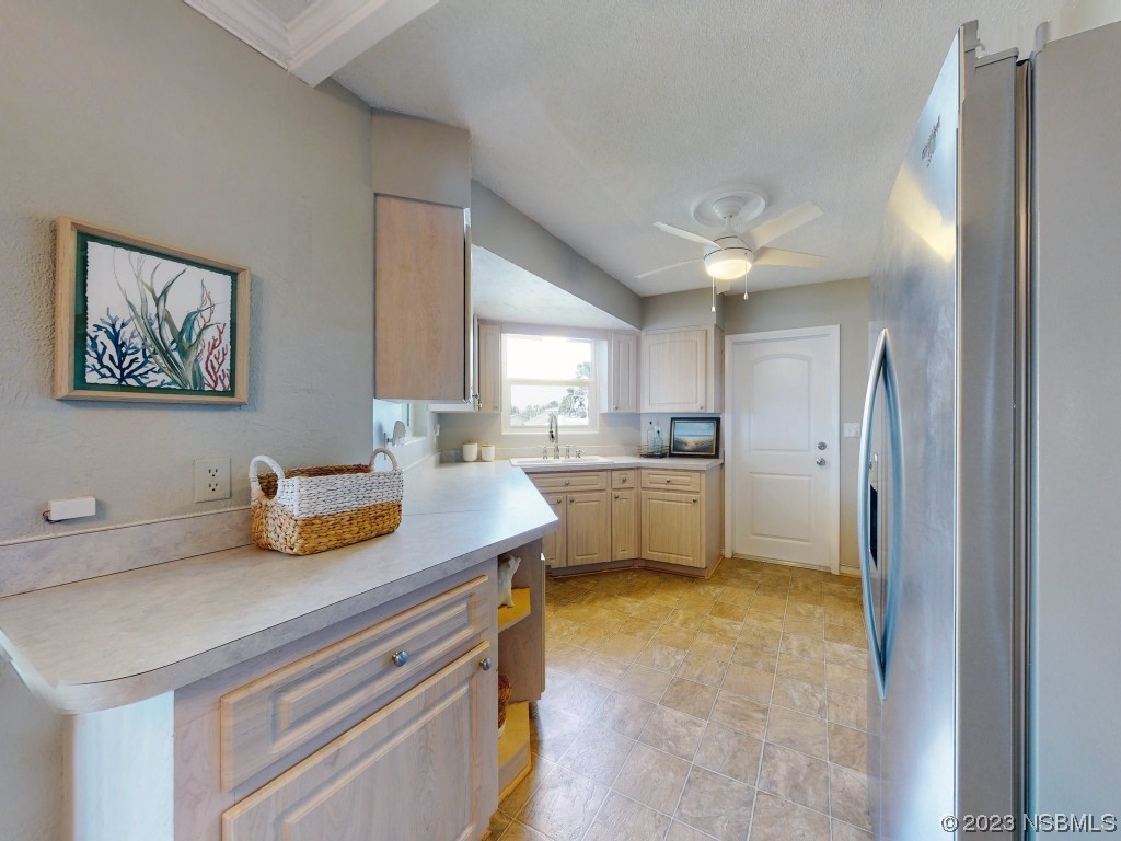 18 Silk Oaks Drive Ormond Beach, FL 32176 - Photo 16 of 46 a kitchen that has a sink a window and stainless steel appliances
