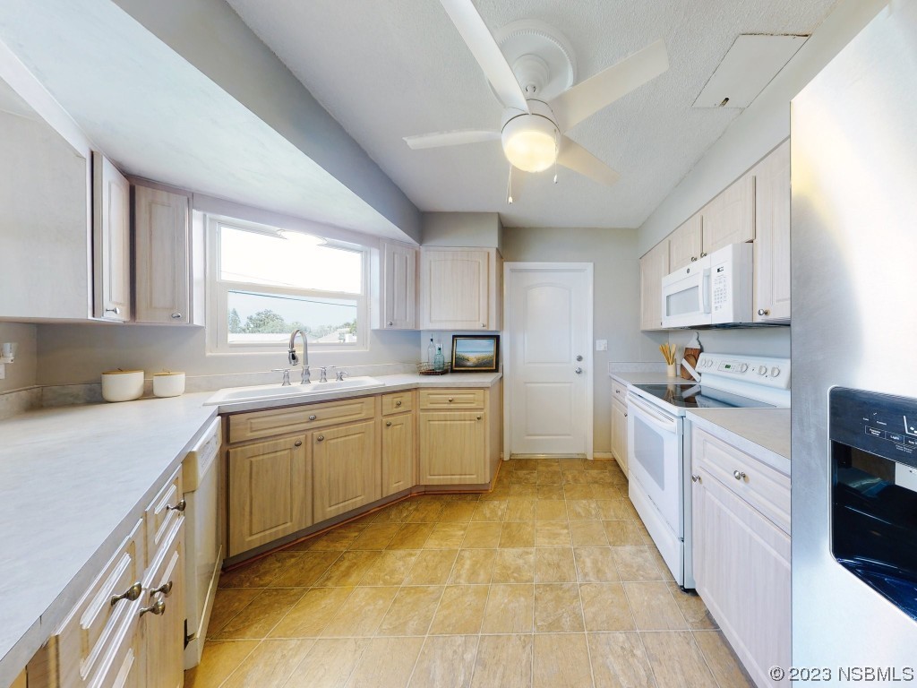 18 Silk Oaks Drive Ormond Beach, FL 32176 - Photo 17 of 46 a kitchen with cabinets appliances and a window