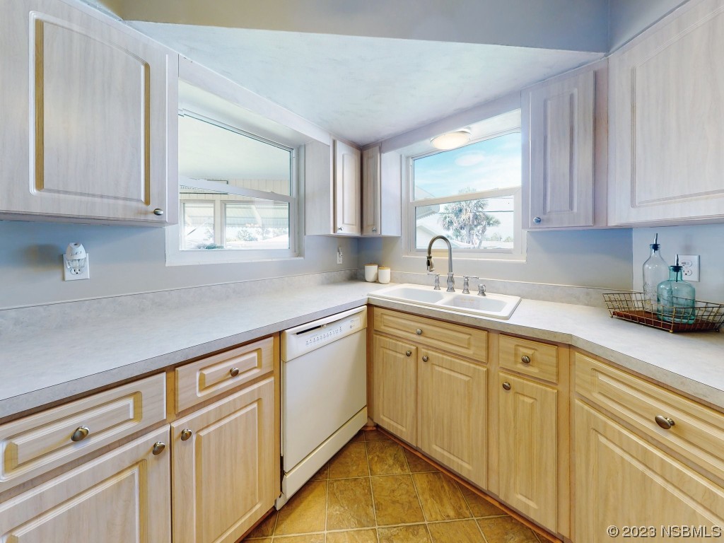 18 Silk Oaks Drive Ormond Beach, FL 32176 - Photo 18 of 46 a kitchen with sink cabinets and window