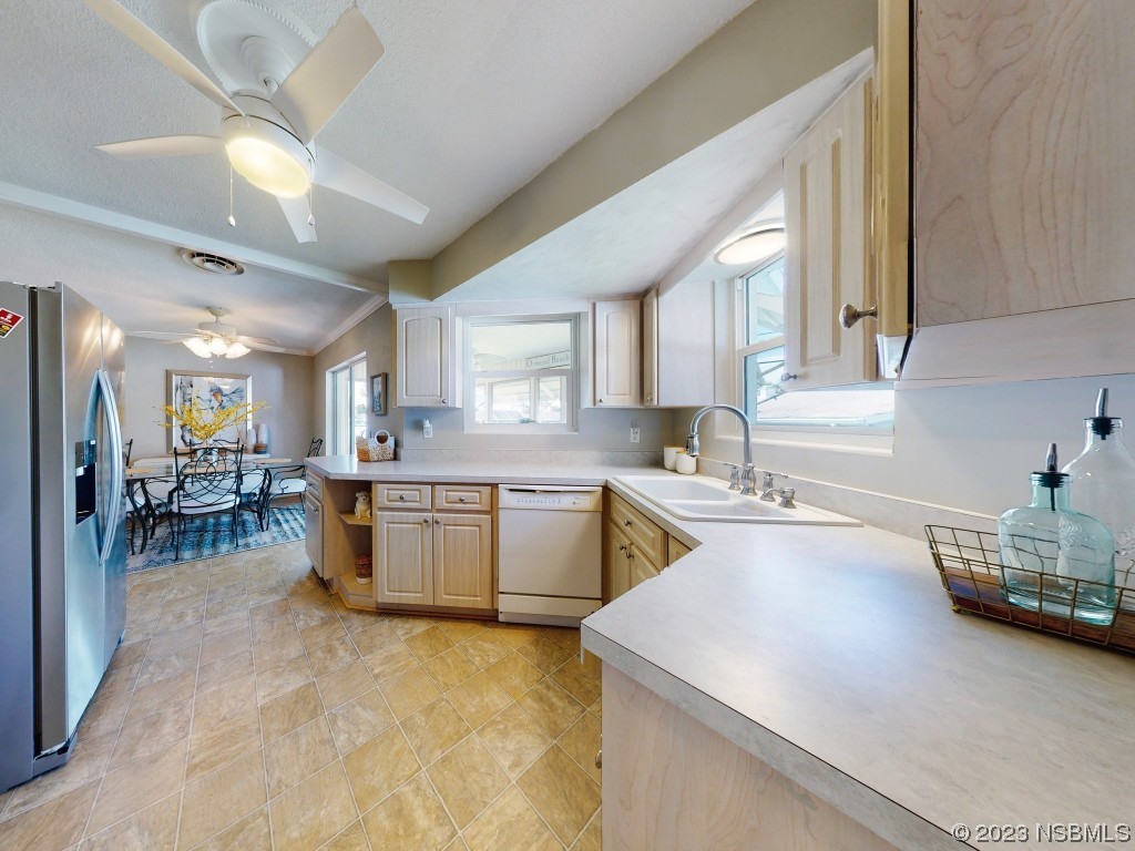 18 Silk Oaks Drive Ormond Beach, FL 32176 - Photo 19 of 46 a kitchen with a table chairs stove and cabinets