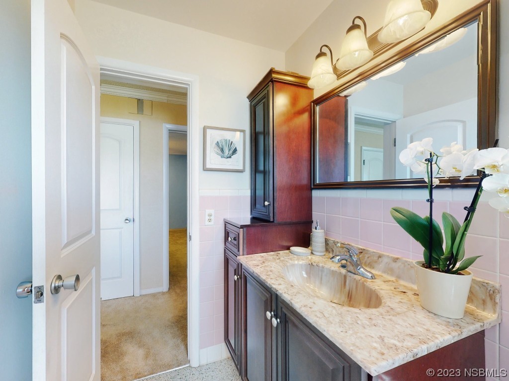 18 Silk Oaks Drive Ormond Beach, FL 32176 - Photo 21 of 46 a bathroom with a granite countertop sink a mirror and a