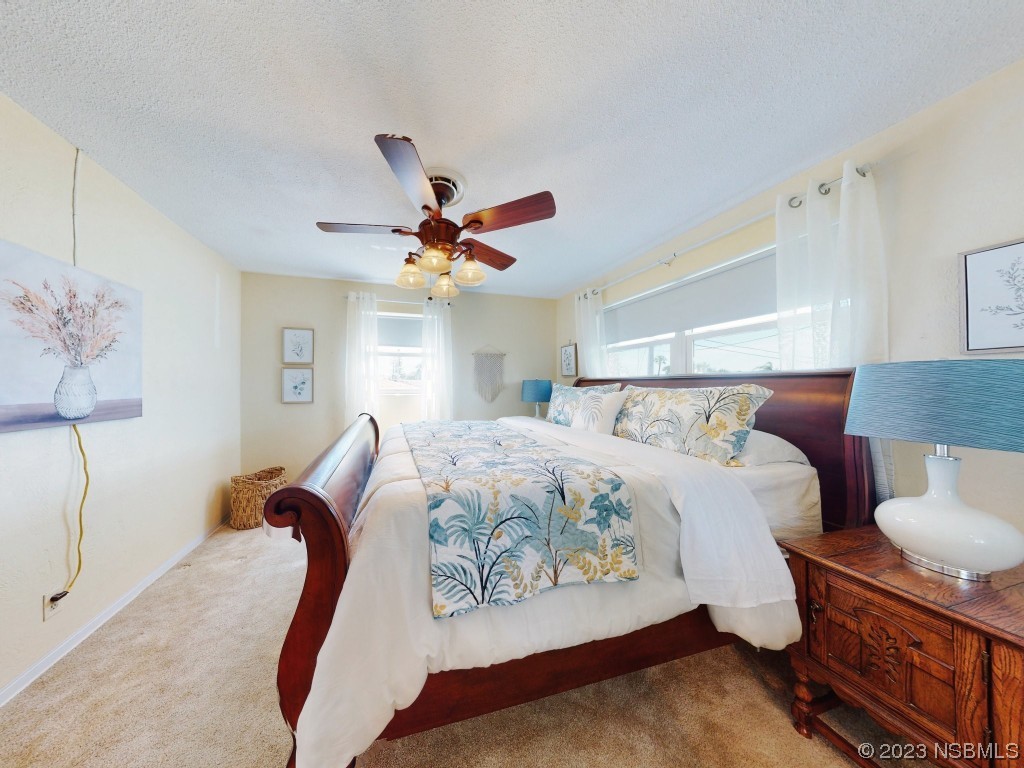 18 Silk Oaks Drive Ormond Beach, FL 32176 - Photo 24 of 46 a bedroom with a bed and wooden floor