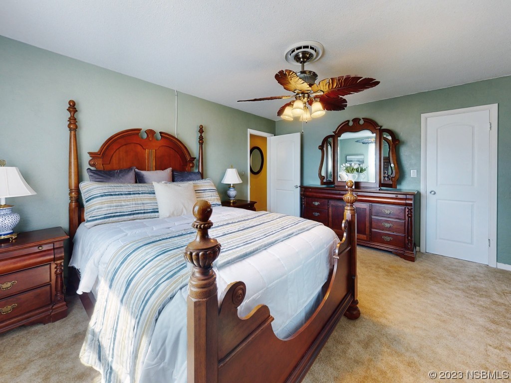 18 Silk Oaks Drive Ormond Beach, FL 32176 - Photo 28 of 46 a bedroom with a bed and a chandelier