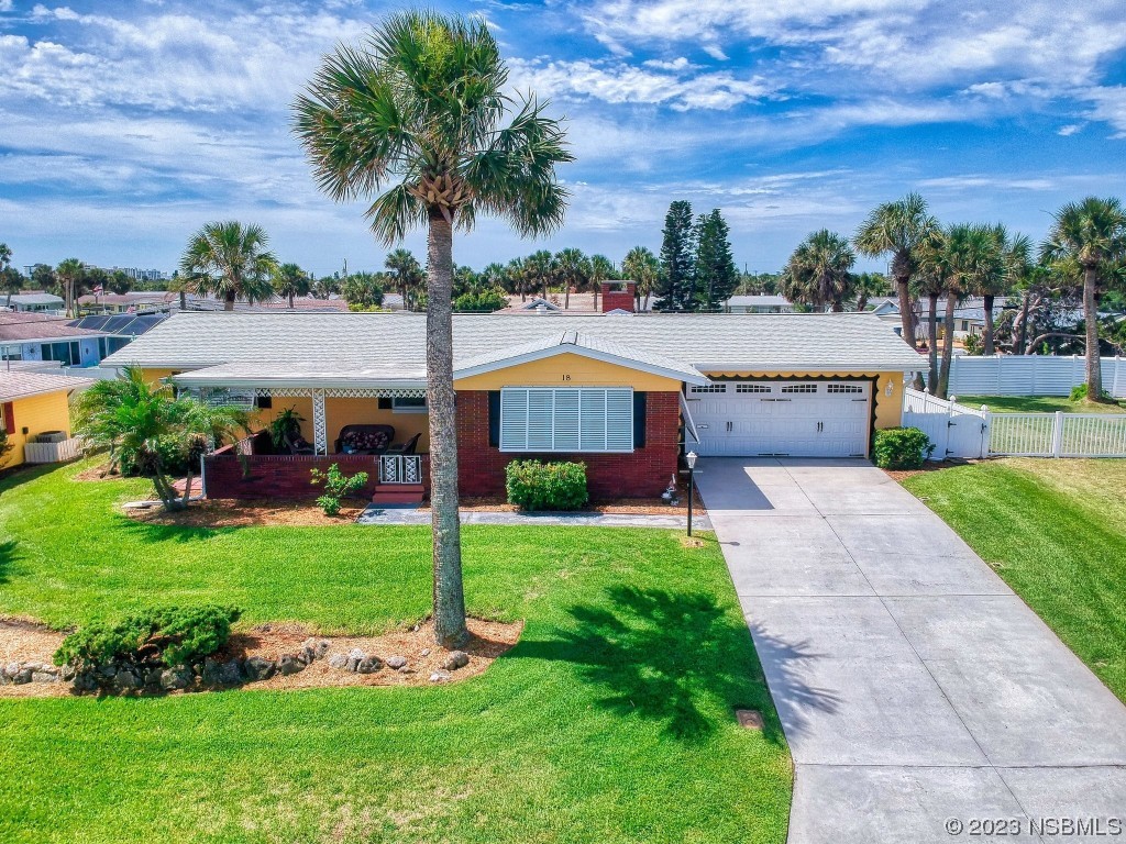 18 Silk Oaks Drive Ormond Beach, FL 32176 - Photo 3 of 46 a front view of house with yard and outdoor seating
