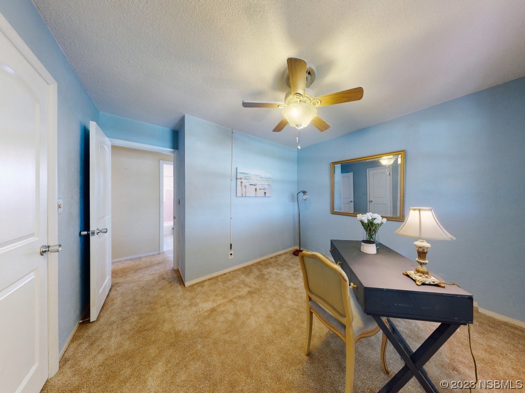 18 Silk Oaks Drive Ormond Beach, FL 32176 - Photo 31 of 46 a bedroom with a bed and a chandelier fan