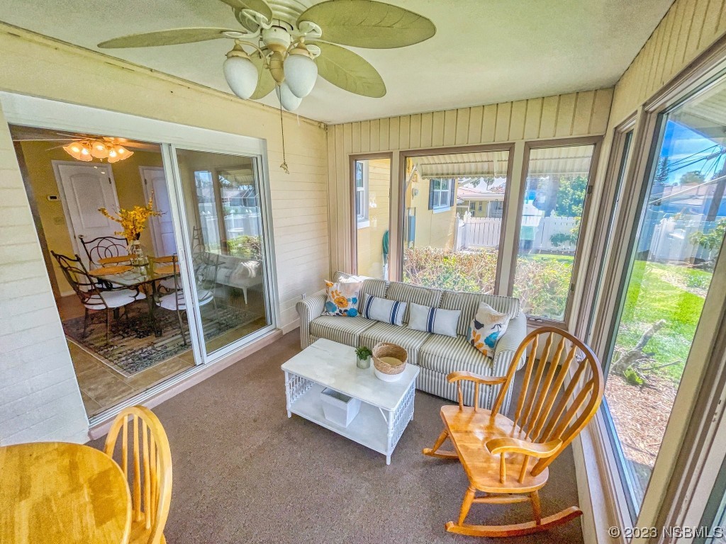 18 Silk Oaks Drive Ormond Beach, FL 32176 - Photo 35 of 46 a living room with furniture and a floor to ceiling window