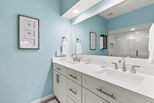 a bathroom with a double vanity sink and a mirror
