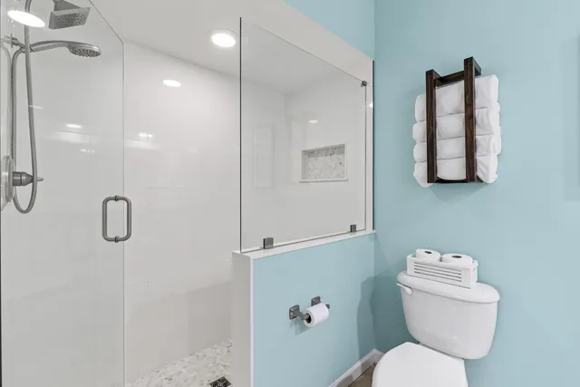 a bathroom with a toilet sink and shower