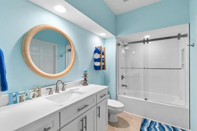 a bathroom with a toilet a sink and a mirror