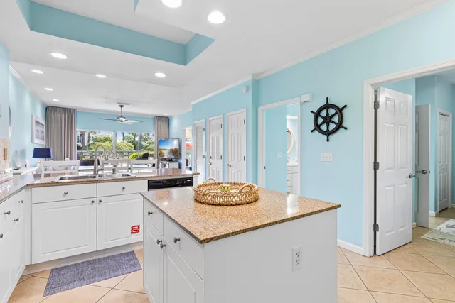 a kitchen with granite countertop white cabinets and white appliances