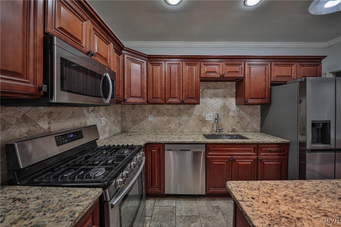 641 7th Avenue Bethlehem, PA 18018 - Photo 12 of 29 a kitchen with stainless steel appliances granite countertop a stove microwave and cabinets
