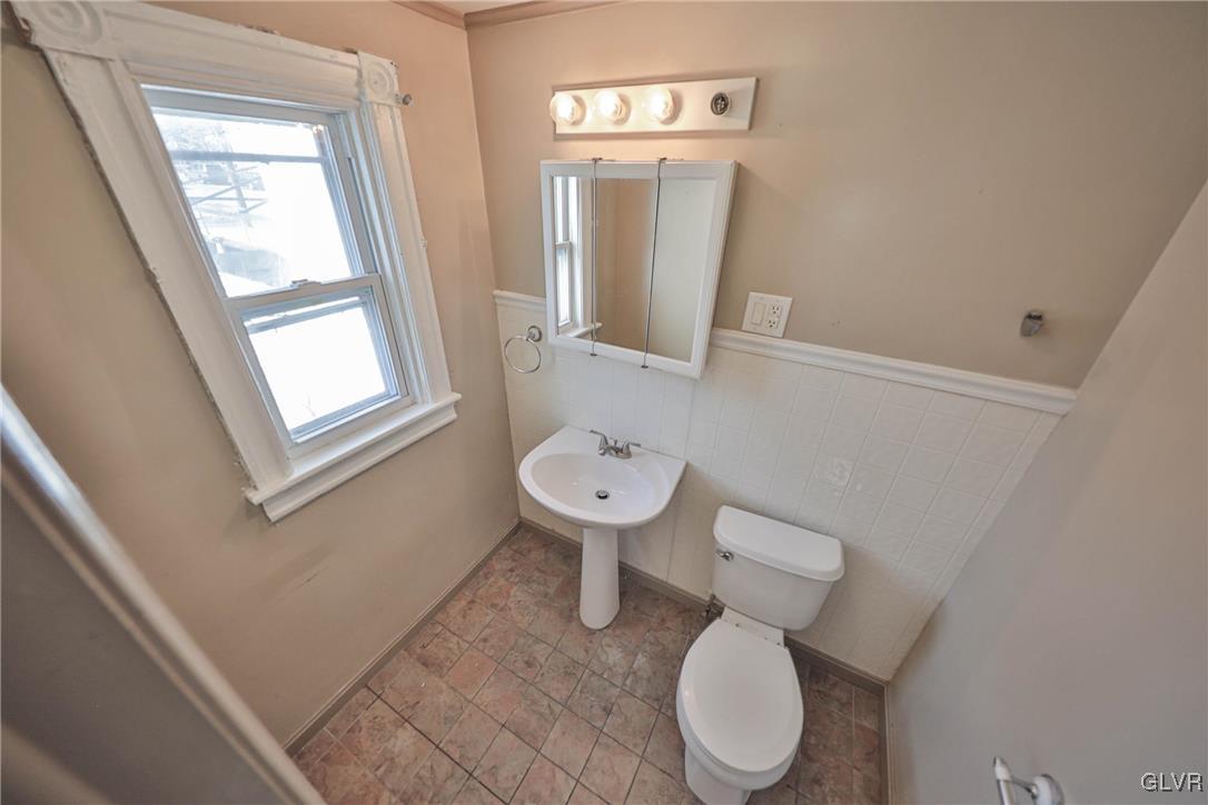 641 7th Avenue Bethlehem, PA 18018 - Photo 16 of 29 a bathroom with a toilet sink and mirror