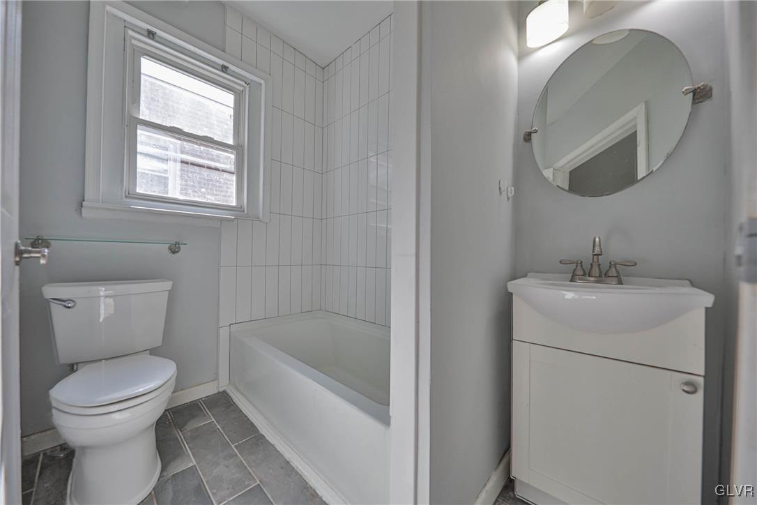 641 7th Avenue Bethlehem, PA 18018 - Photo 19 of 29 a bathroom with a toilet sink and mirror