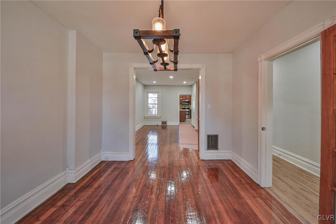 641 7th Avenue Bethlehem, PA 18018 - Photo 5 of 29 a view of a room with wooden floor staircase and a kitchen