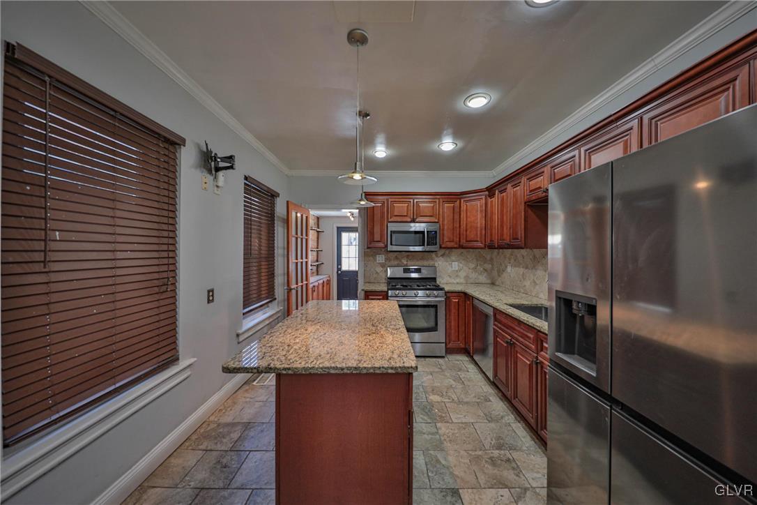 641 7th Avenue Bethlehem, PA 18018 - Photo 9 of 29 a large kitchen with stainless steel appliances kitchen island granite countertop a large counter top space and stainless steel appliances