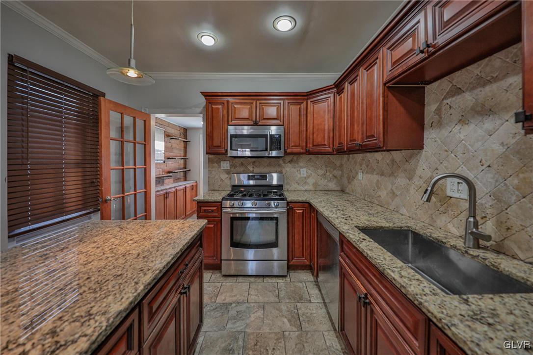 641 7th Avenue Bethlehem, PA 18018 - Photo 10 of 29 a kitchen with kitchen island granite countertop a sink stove and cabinets