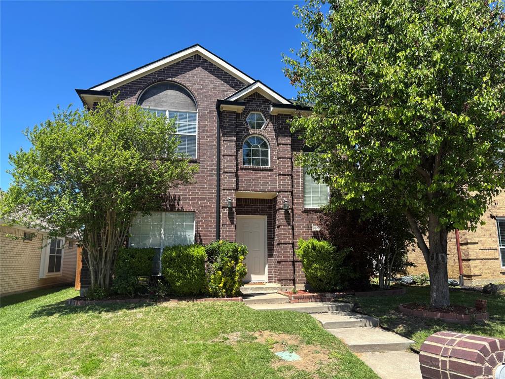 1332 West Branch Hollow Drive Carrollton, TX 75007 - Photo 1 of 20 a front view of a house with a yard