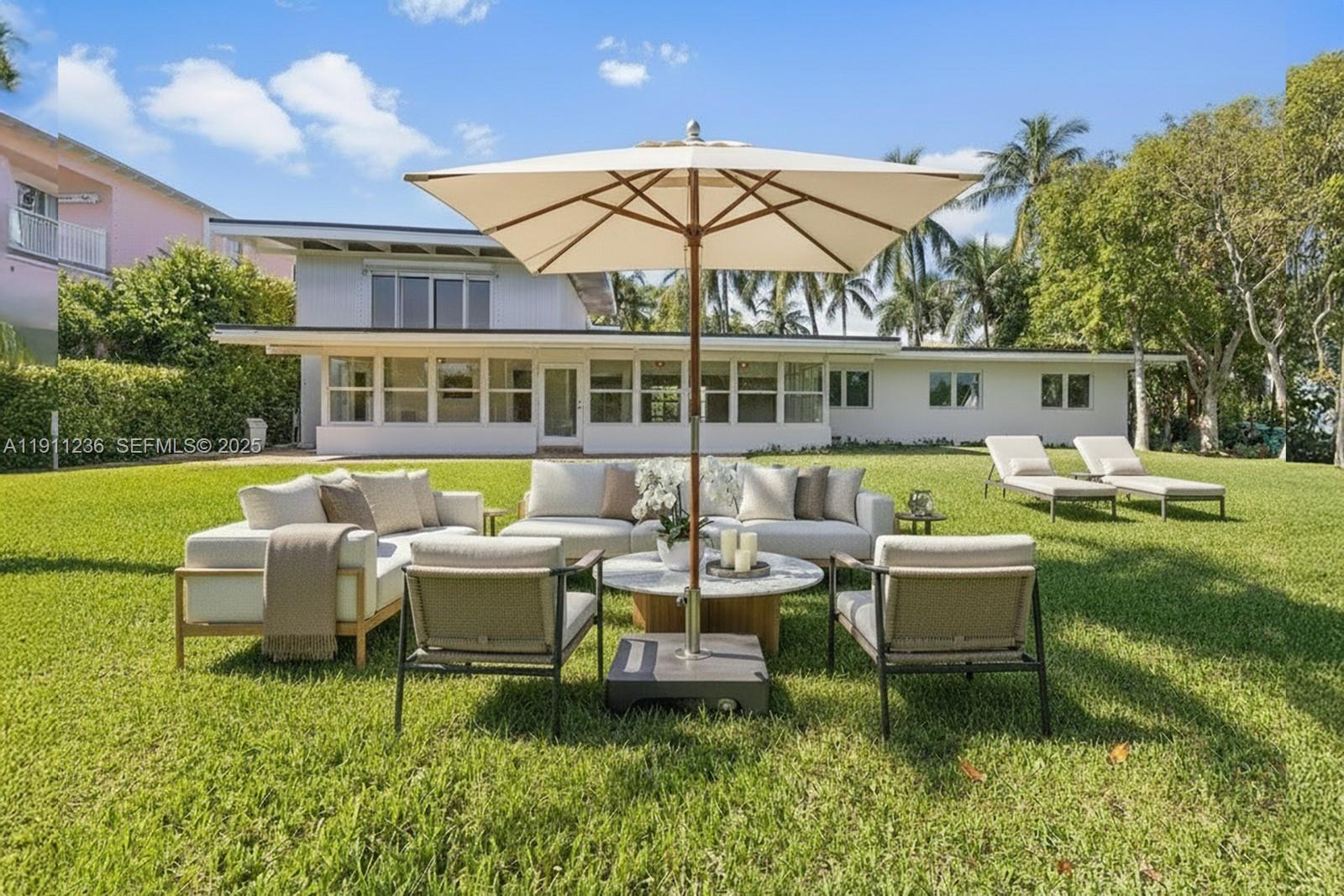 4 Harbor Point Key Biscayne, FL 33149 - Photo 3 of 30 a view of a house with backyard sitting area and swimming pool