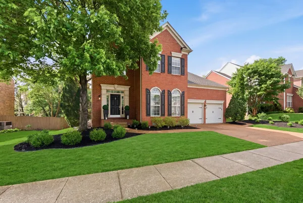 a front view of a house with a yard