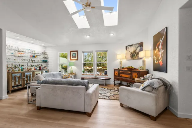 a kitchen with stainless steel appliances wooden floor dining table and chairs