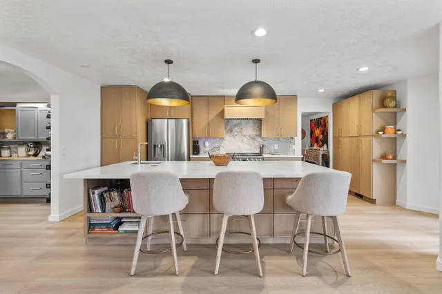 a kitchen with a wooden floor and a fireplace