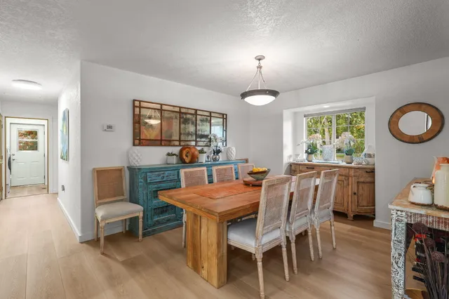a living room with furniture a ceiling fan and a window