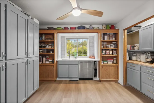 a spacious bathroom with a granite countertop sink and a mirror