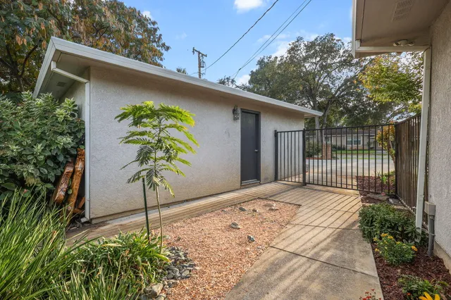 a view of a patio with table and chairs under an umbrella