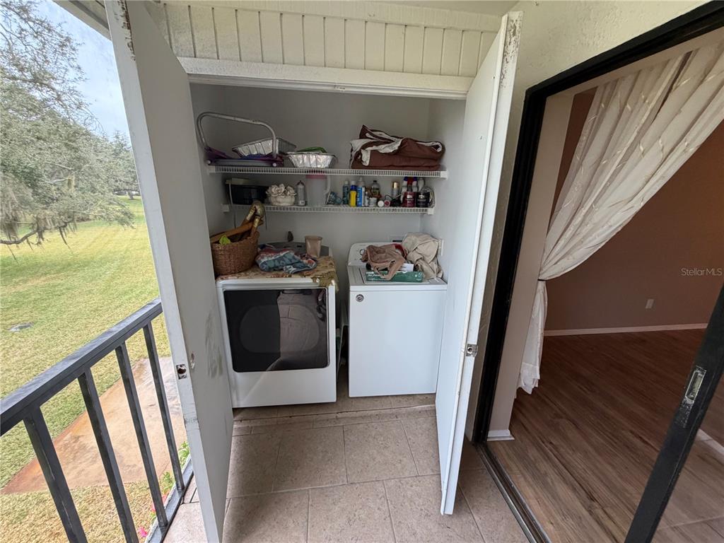 274 Cypress Lane Oldsmar, FL 34677 - Photo 17 of 19 a view of washer and dryer with wooden floor