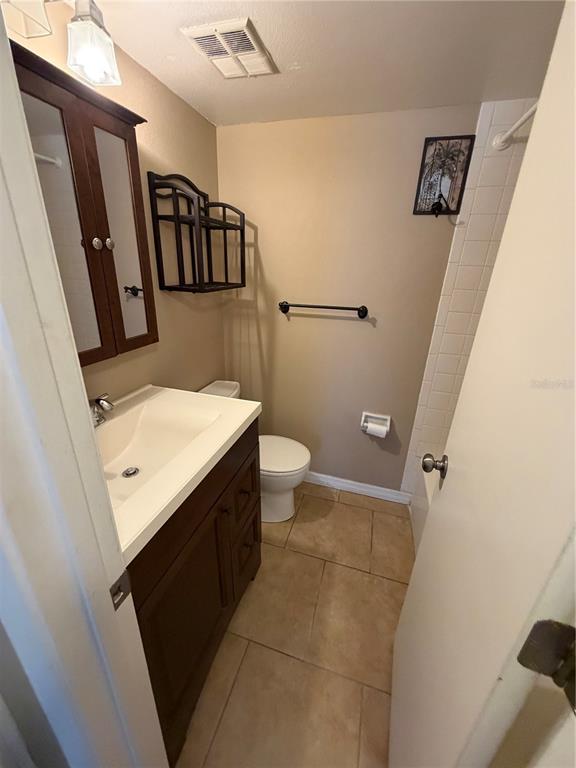274 Cypress Lane Oldsmar, FL 34677 - Photo 10 of 19 a bathroom with a sink a toilet a mirror and shower