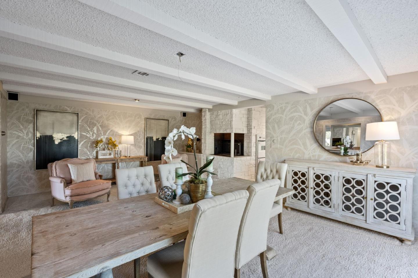 130 Lynn Way Woodside, CA 94062 - Photo 18 of 47 a living room with furniture a mirror and a potted plant