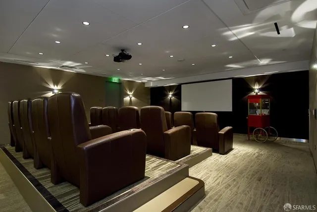 a media room with lots of chairs and a projector screen