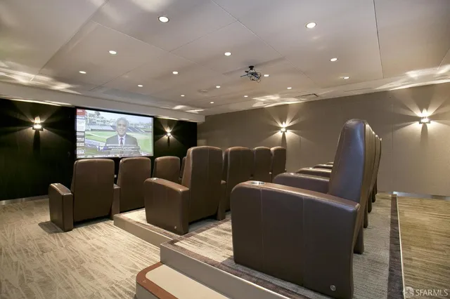 a media room with lots of chairs and a projector screen