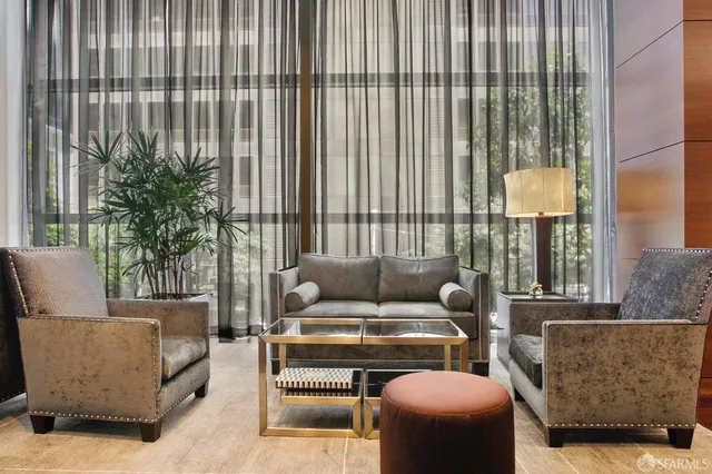 a living room with furniture and a lamp