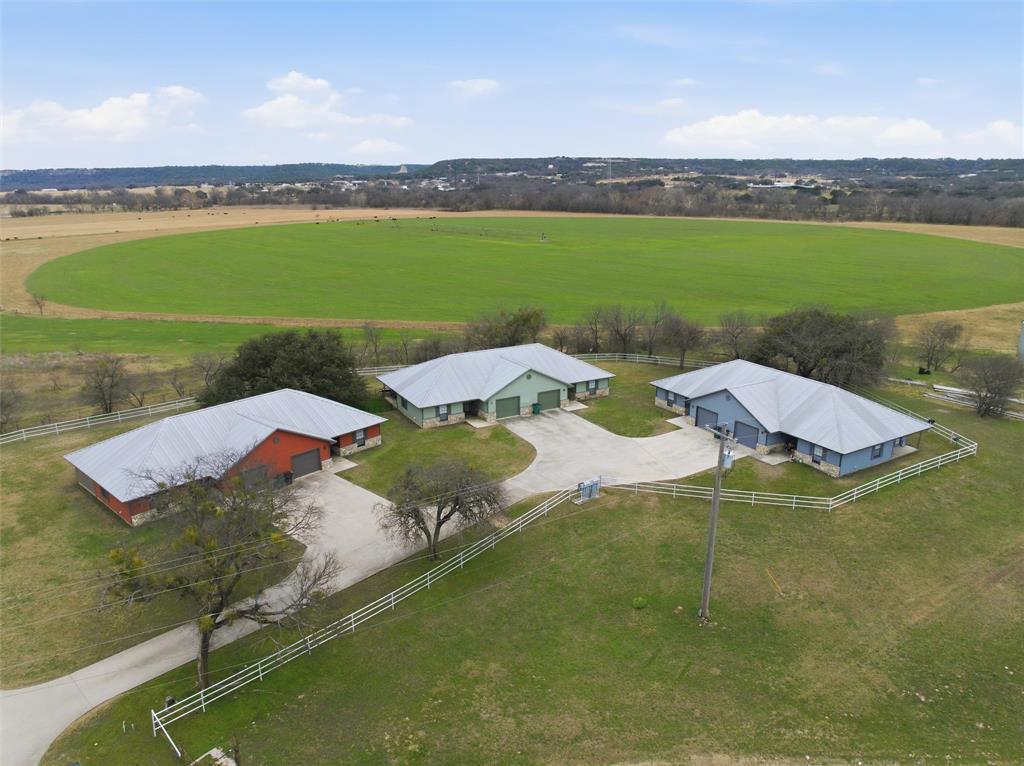 an aerial view of a house with a garden and lake view