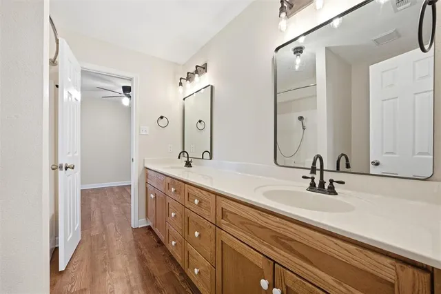a bathroom with a double vanity sink mirror and double