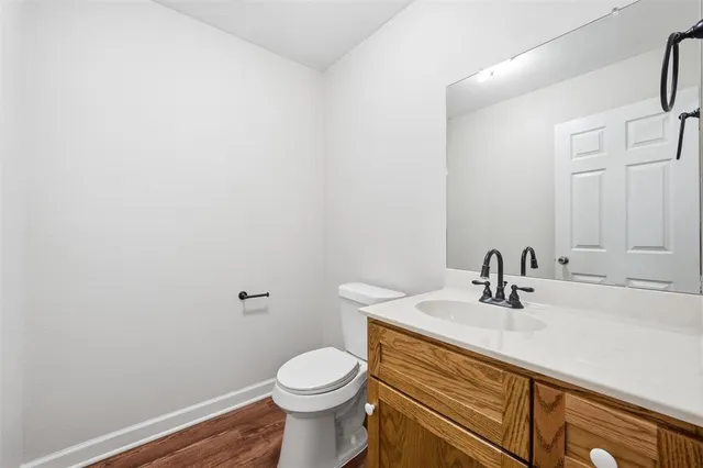 a bathroom with a sink a toilet and mirror