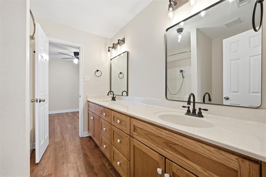 710 Erath Street Meridian, TX 76665 - Photo 15 of 26 a bathroom with a double vanity sink mirror and double