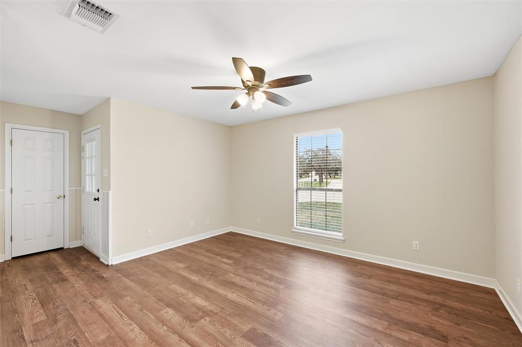 710 Erath Street Meridian, TX 76665 - Photo 19 of 26 wooden floor in an empty room with a window