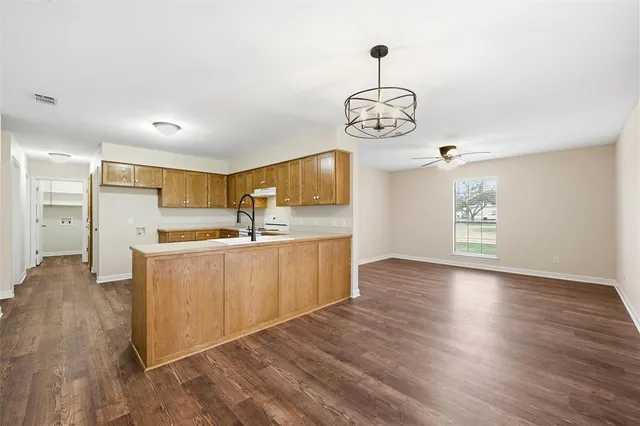 a view of kitchen with wooden floor and window