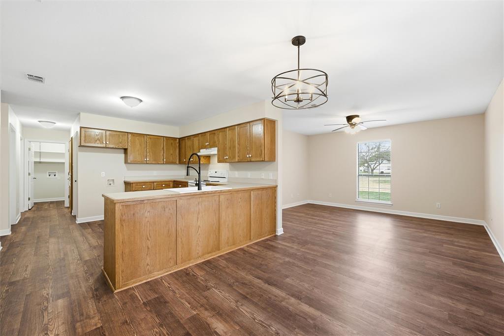 710 Erath Street Meridian, TX 76665 - Photo 8 of 26 a view of kitchen with wooden floor and window