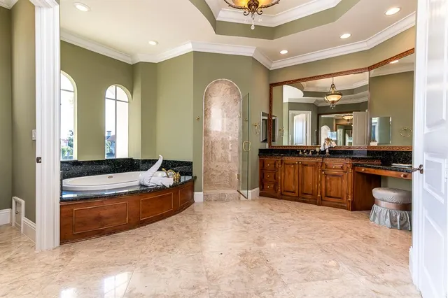 a large spacious bathroom with a large tub and sink