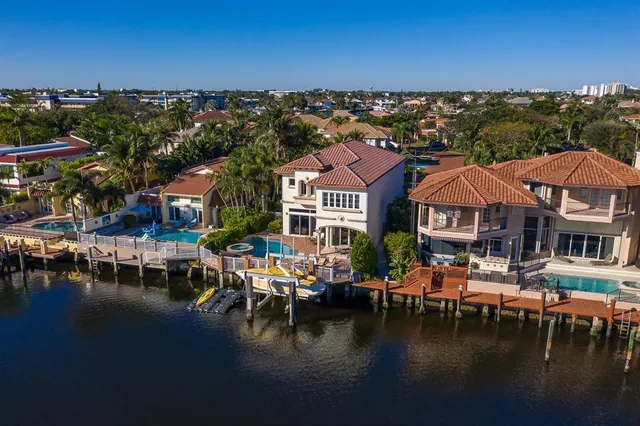 a view of a lake with a house swimming pool and outdoor space