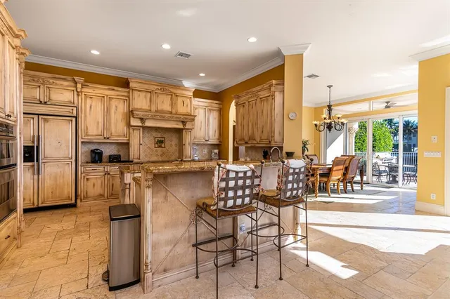 a kitchen with stainless steel appliances kitchen island granite countertop a refrigerator and cabinets